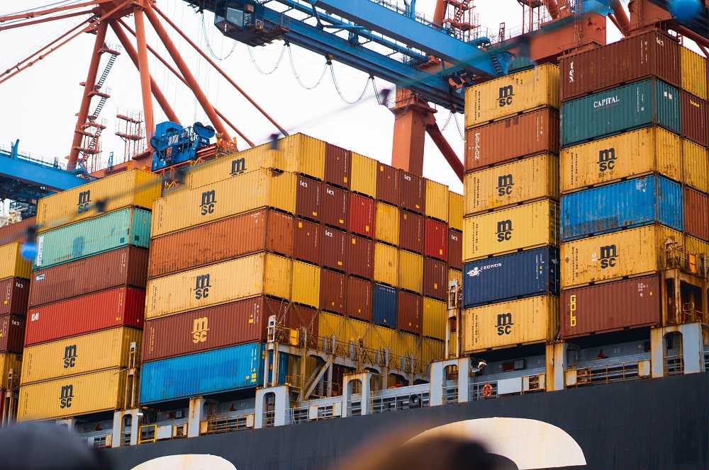Container ship at port with gantry cranes
